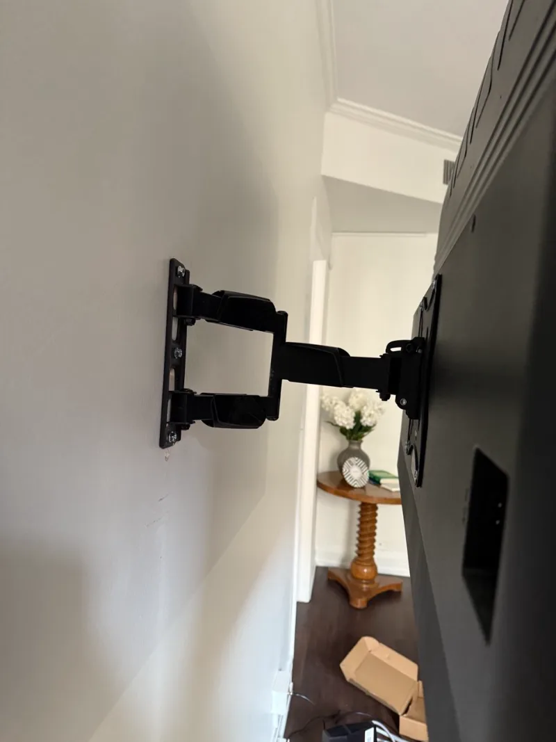 Full-motion TV mount with swivel arm installed in a Chicago apartment