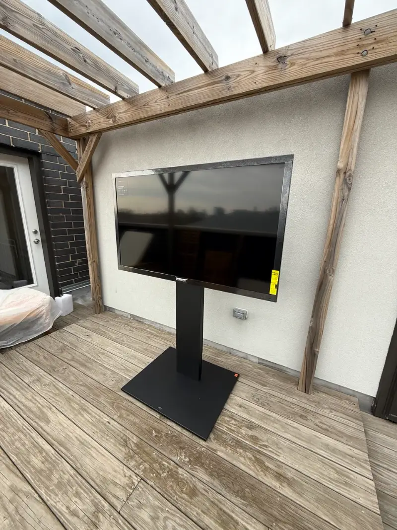 Outdoor TV installed on a rooftop deck under a pergola in Chicago