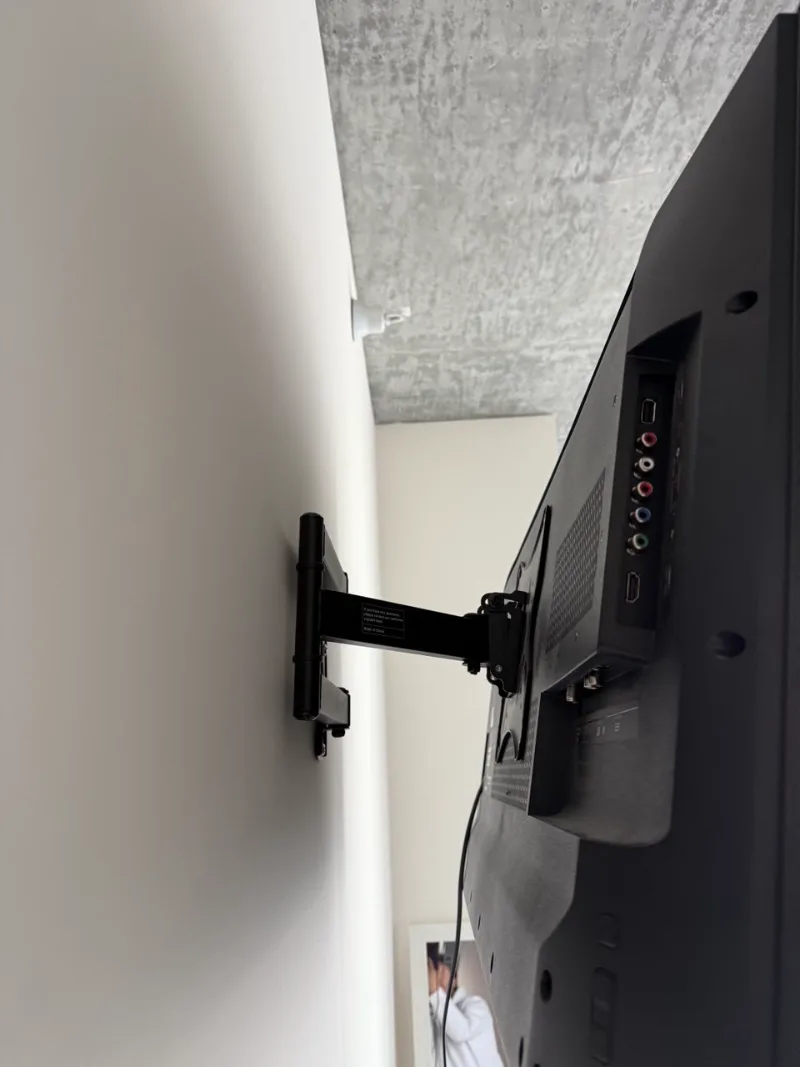 Back of a TV on a full-motion mount in a Chicago loft