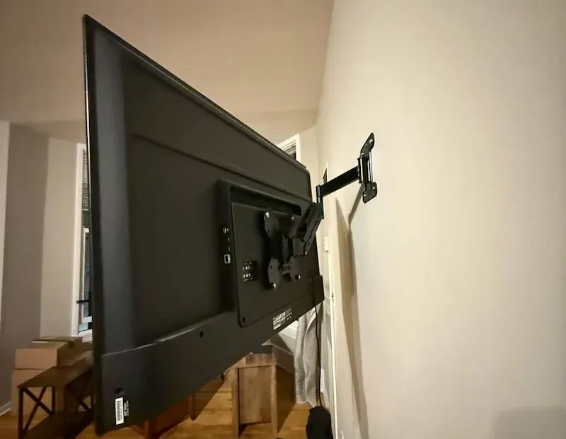 TV on a full-motion mount pulled away from the wall for cable access