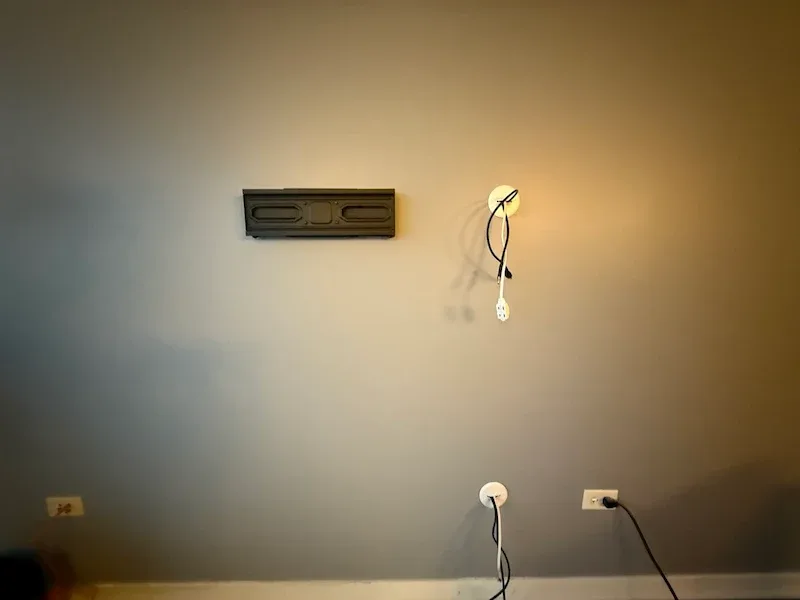 TV mount bracket and recessed wall outlet installed before hanging the TV