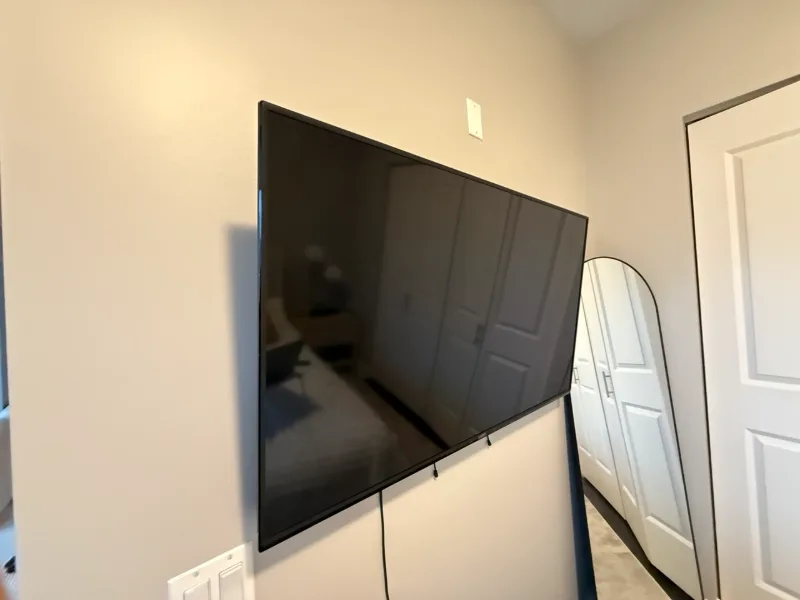 TV wall mounted opposite the closet in a Chicago bedroom