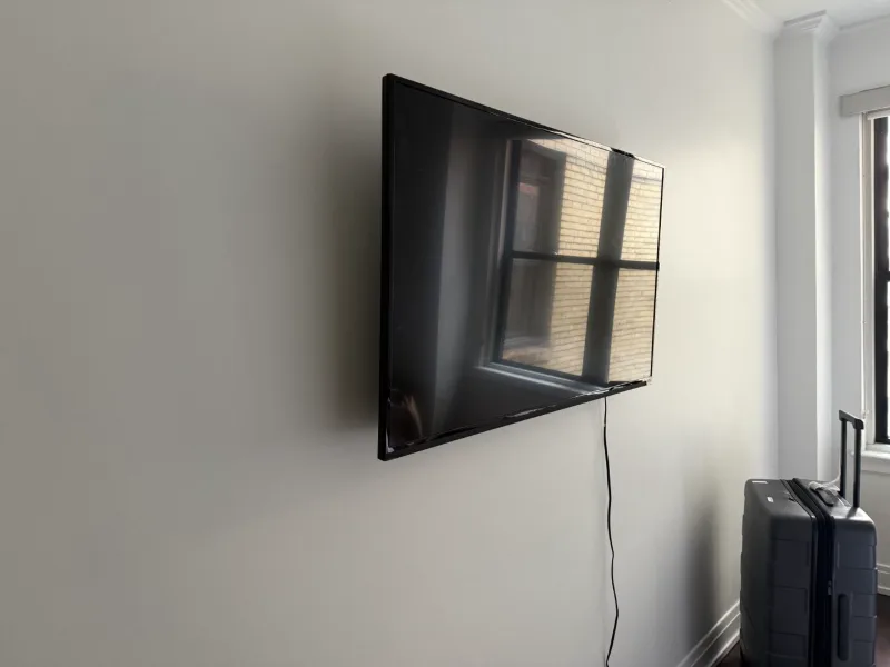 TV wall mounted in the bedroom of a vintage Chicago apartment