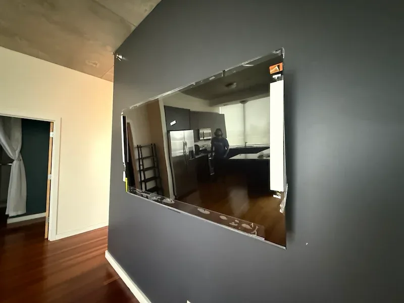 TV wall mounted on a dark accent wall in a Chicago loft