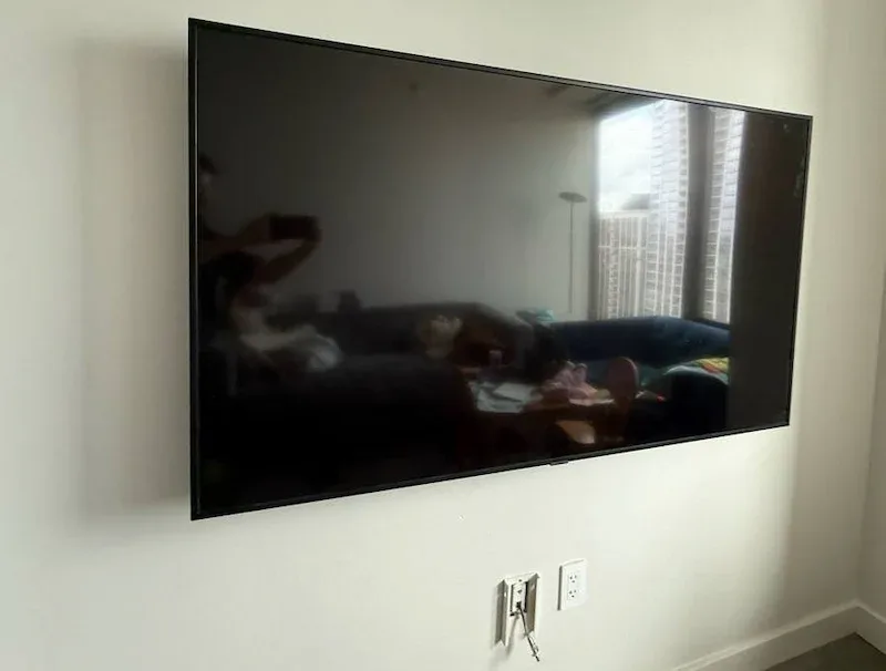 65-inch TV wall mounted on drywall with cables hidden in a Chicago condo