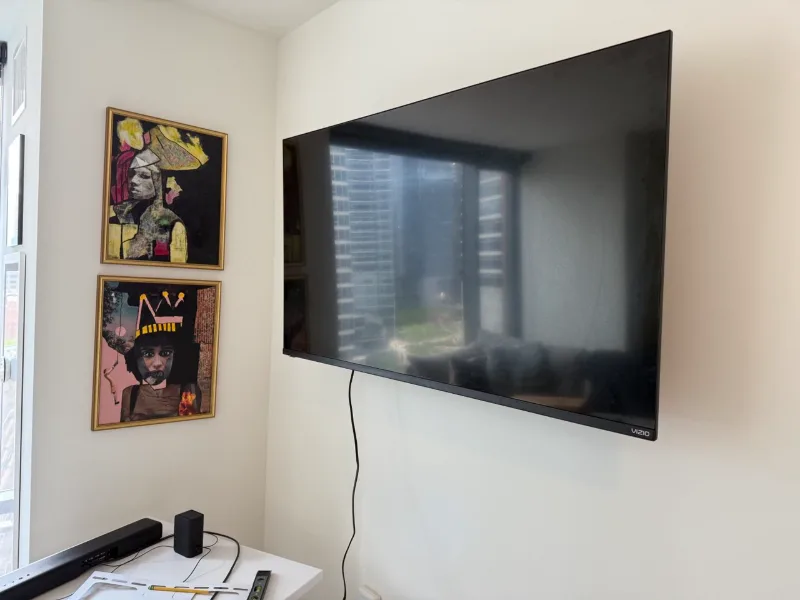 Vizio TV mounted on a corner wall in a Chicago condo